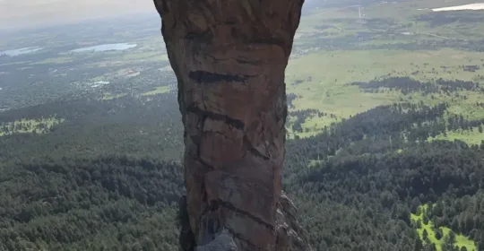 A rock climber descending to the Crow's Nest on the Maiden in Boulder Colorado