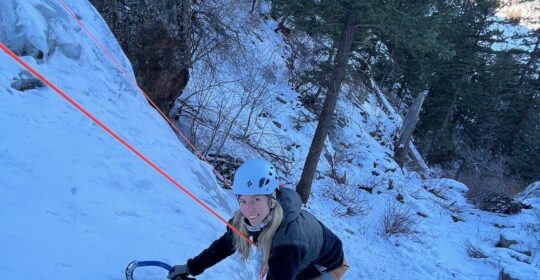 Introduction to ice climbing student climbing ice in Golden Colorado