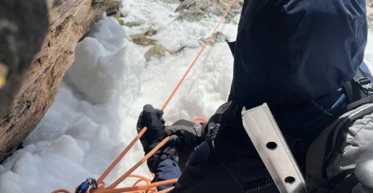 Advanced mountaineering student practicing belaying in Colorado