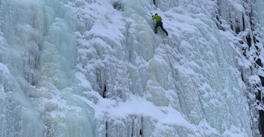 An ice climber leading a pitch in Alaska