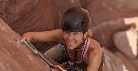 A rock climber on the bolted face of Ancient Art in Moab Utah