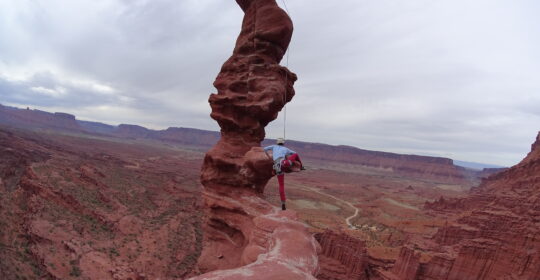 A climber on the diving board of Ancient Art in Moab Utah