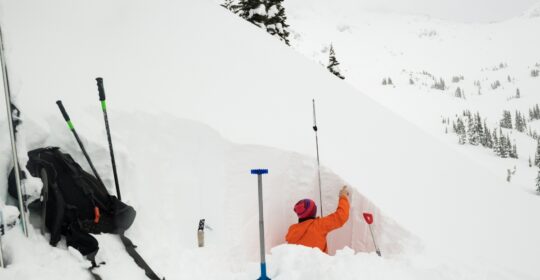 An avalanche educator digging a snow pit in Colorado