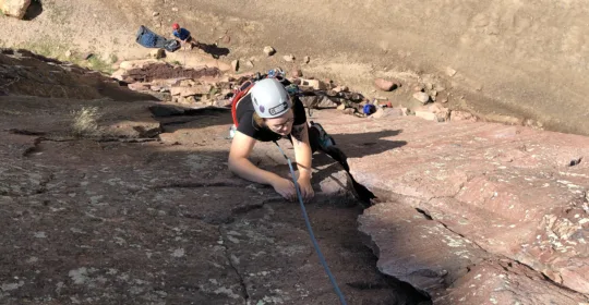 A rock climber on the classic Bastille Crack in Boulder Colorado