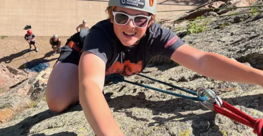 Beginner climbing course student rock climbing in Clear Creek Canyon Colorado