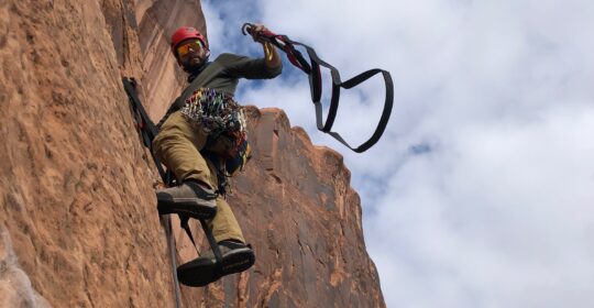 A bigwall climbing course student learning how to aid climb in Moab Utah