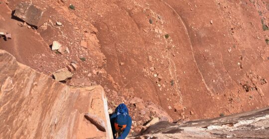 A rock climber on pitch one of North Chimney on Castleton Tower in Moab Utah