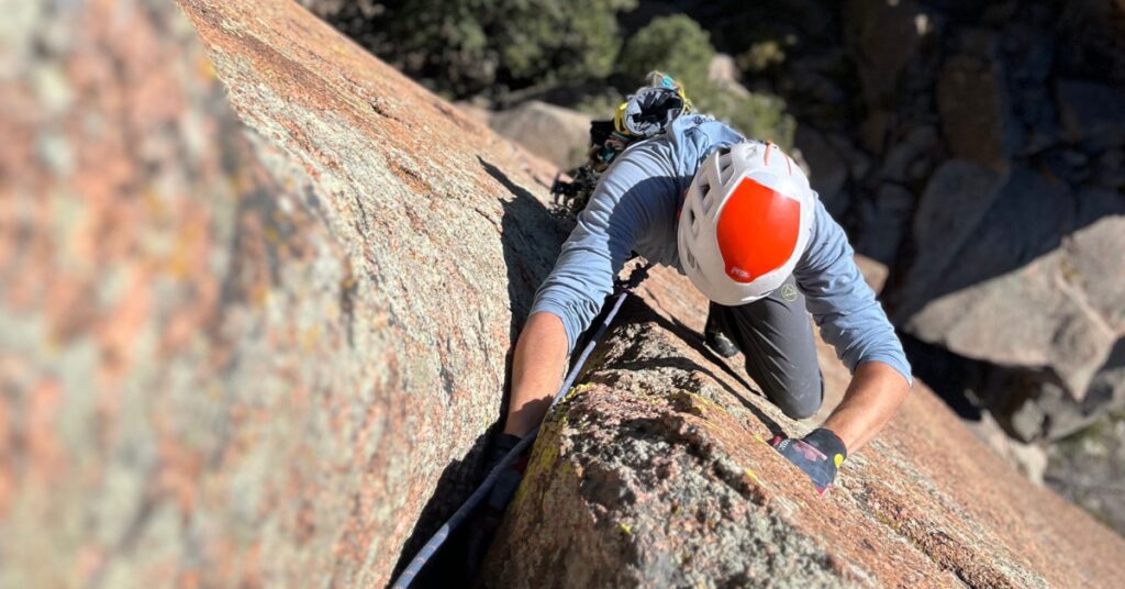 A rock climber in Colorado hand-jamming in the Cathedral Spires