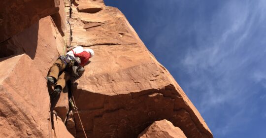 Climbing progression course student crack climbing in Moab Utah
