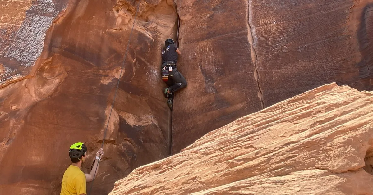 Crack climbing student learning how to jam