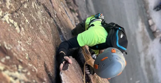 Crack climbing student using a handjam to climb a crack