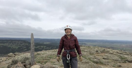 A rock climber at the top of Devils Tower in Wyoming