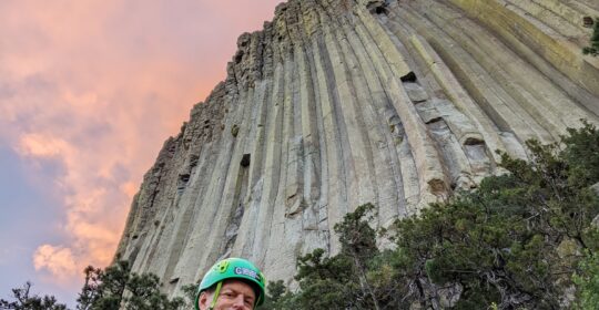 A climber looking up at Devils Tower in Wyoming