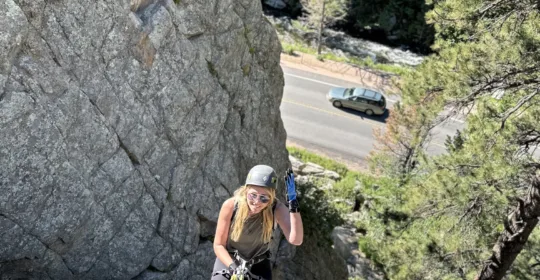 A gym to crag student rappelling in Boulder Colorado