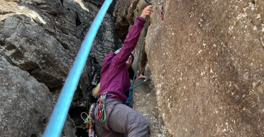 Learn to lead climb student clipping a quickdraw