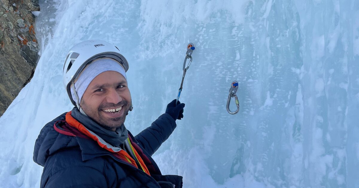 An ice climbing student learns about ice anchors at Lincoln Falls in Colorado