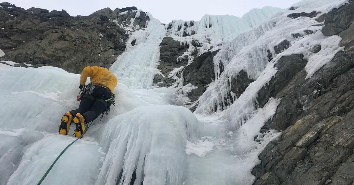 A guide demonstrates good technique in the steep ice climbing course in Colorado