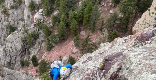 A climber high on Swanson Arete in Boulder Colorado