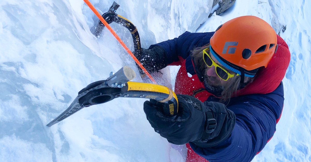 An ice climber hits the ice on a beginner ice climbing tour in Colorado
