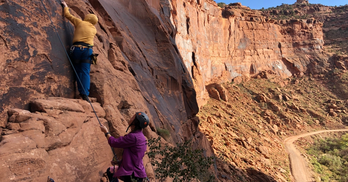 Rock climbers scaling walls at the Ice Cream Parlor in Moab Utah