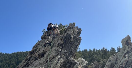 A climber practicing mountaineering skills in Boulder Colorado