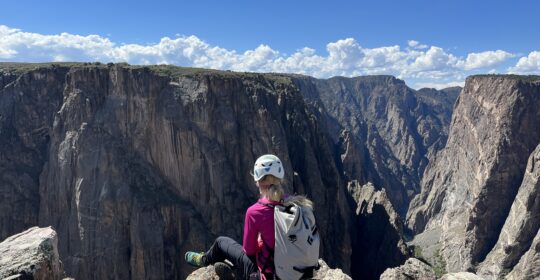 A rock climber enjoying the views from the top of the Black Canyon of the Gunnison in Colorado