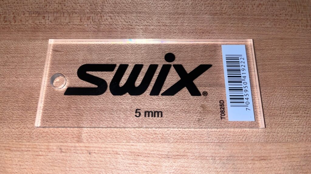 Ski scraper in a backcountry ski repair kit