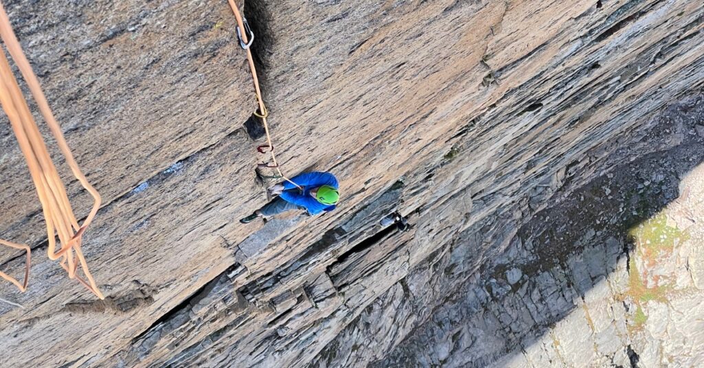 A rock climber high on Longs Peak climbing splitter cracks on the Diamond Face