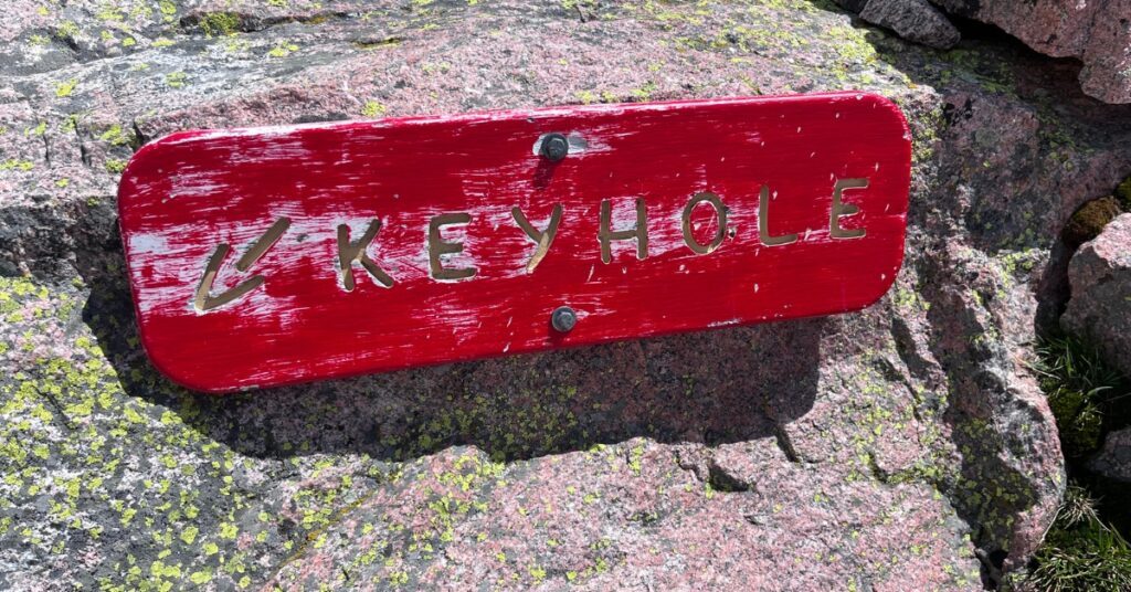 The red Keyhole route sign on Longs Peak