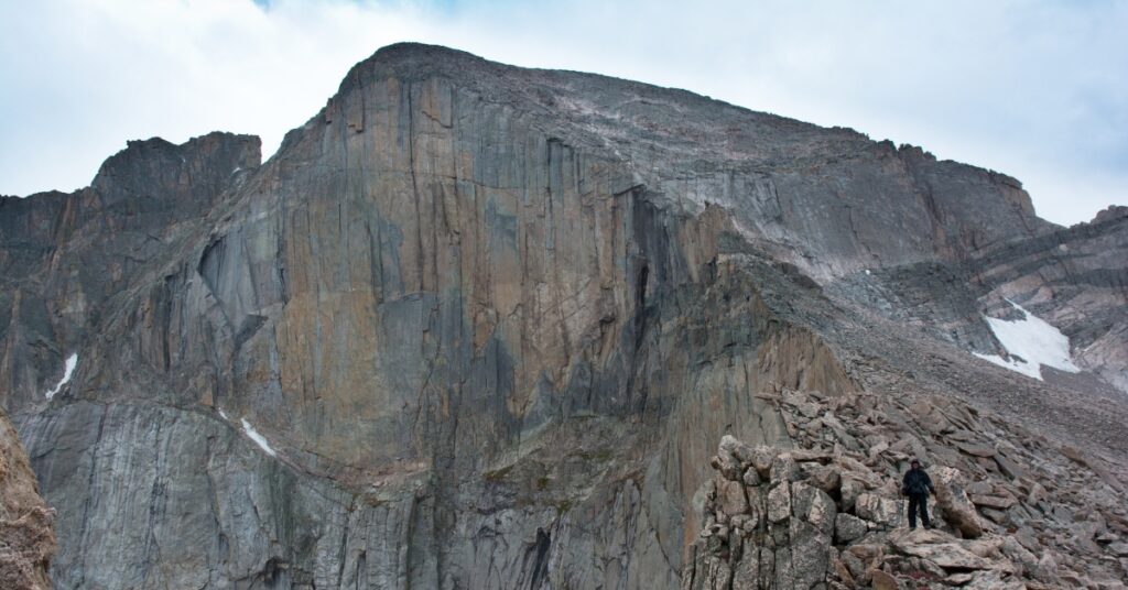 A climber looking at the Diamond Face on Longs Peak after a successful alpine rock climbing day