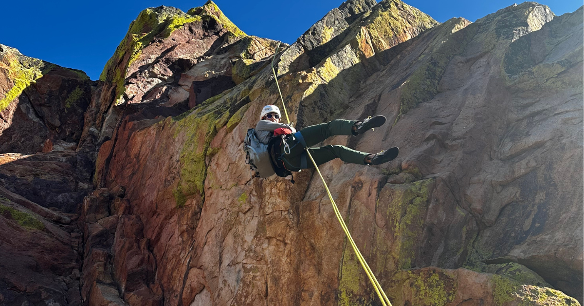 Climber in a rappelling course